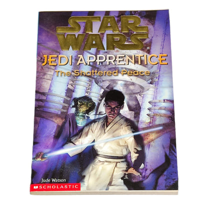 Book titled 'Jedi Apprentice: The Shattered Peace' by Jude Watson on a dark textured background