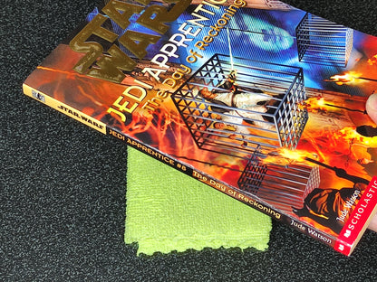 Book titled 'Jedi Apprentice' on a textured surface with a green cloth underneath