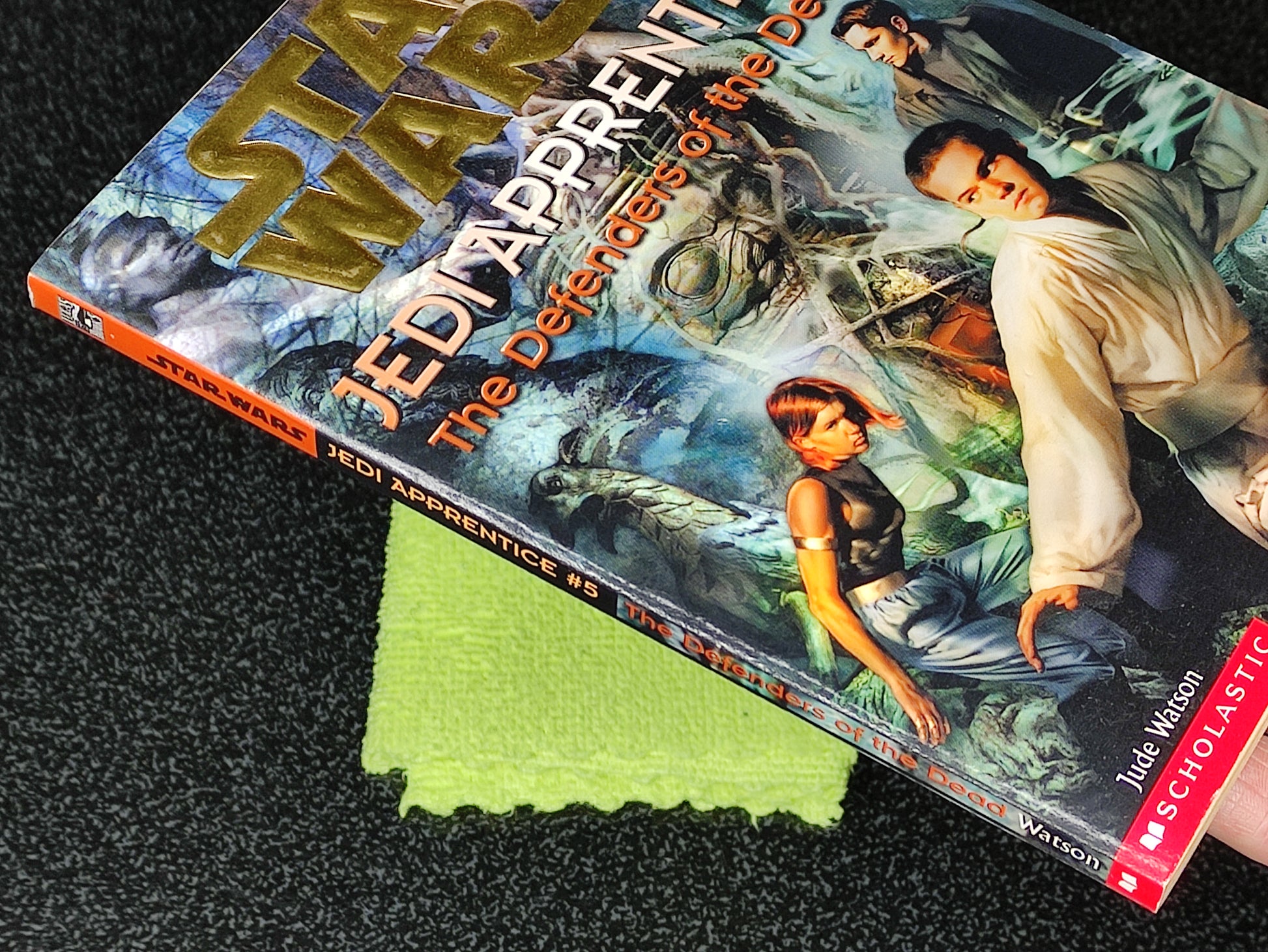 Star Wars Jedi Apprentice book on a textured surface with a green cloth underneath