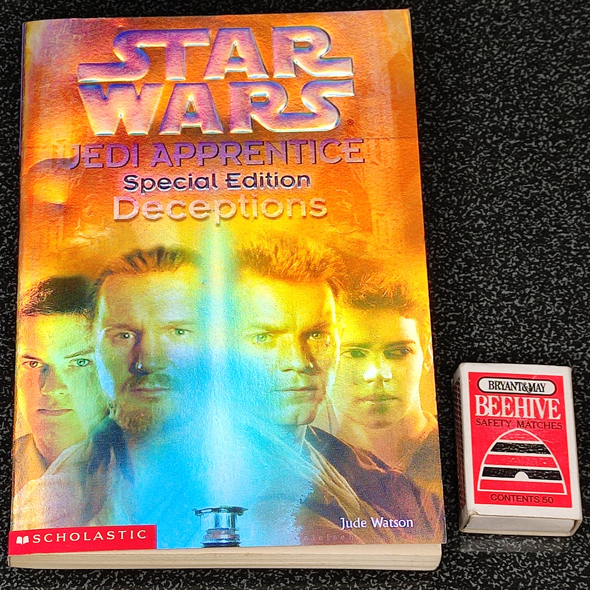 Book titled 'Star Wars Jedi Apprentice: Deceptions' by Jude Watson on a black textured background