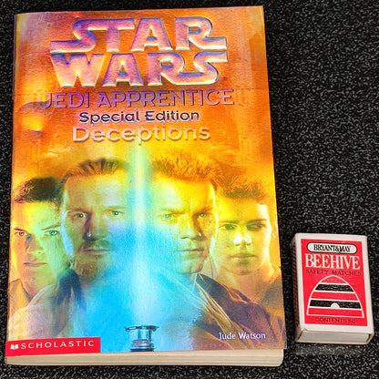 Book titled 'Star Wars Jedi Apprentice: Deceptions' by Jude Watson on a black textured background
