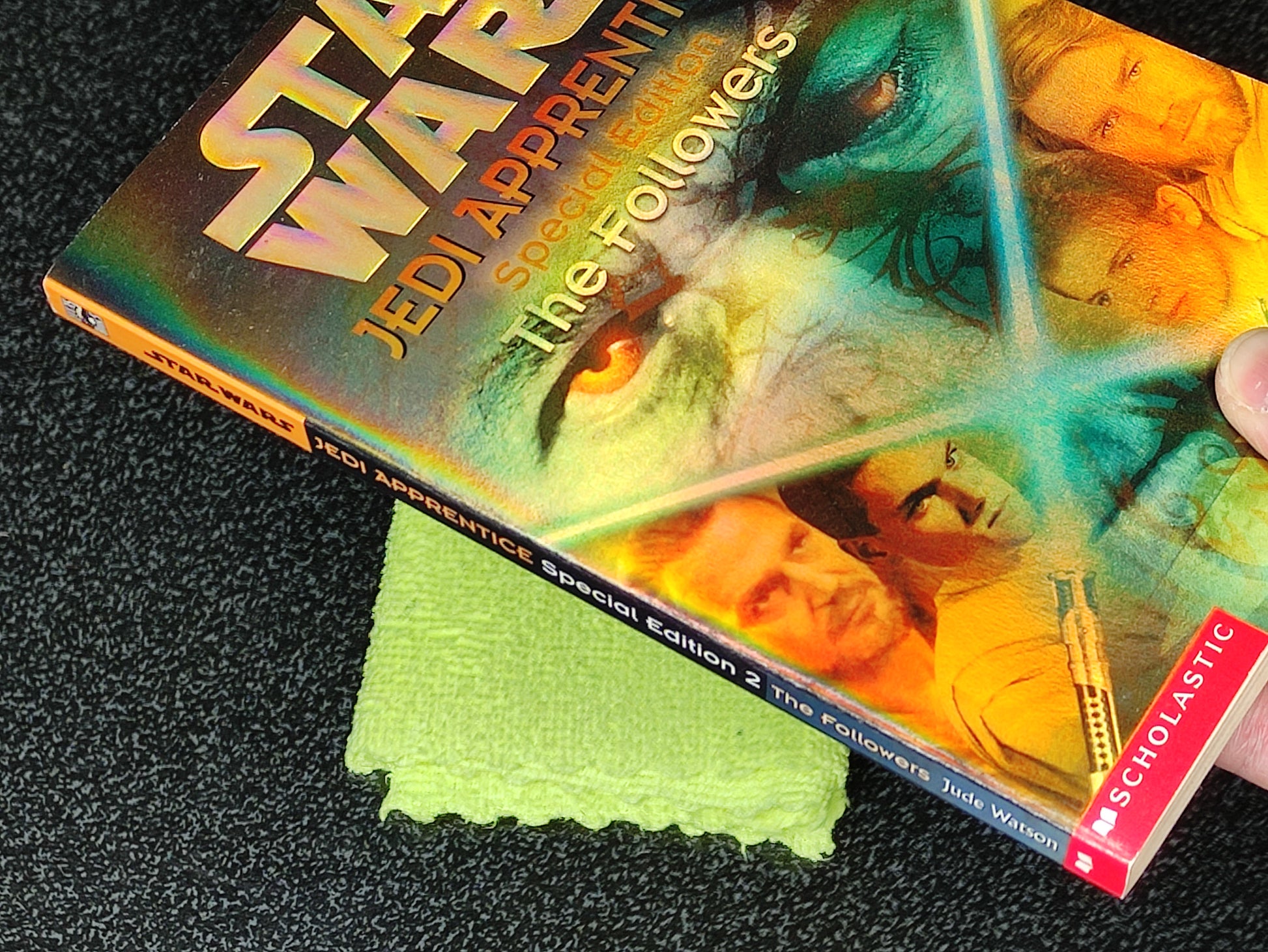 Star Wars Jedi Apprentice book with a green cloth on a dark surface