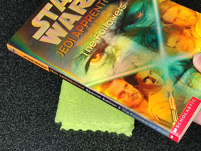 Star Wars Jedi Apprentice book with a green cloth on a dark surface