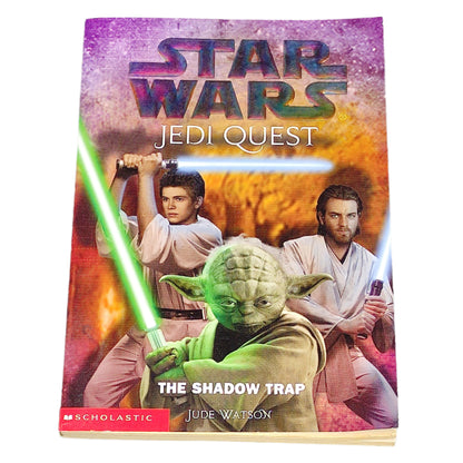 Book cover of 'Star Wars Jedi Quest: The Shadow Trap' featuring characters with lightsabers on a dark textured background.