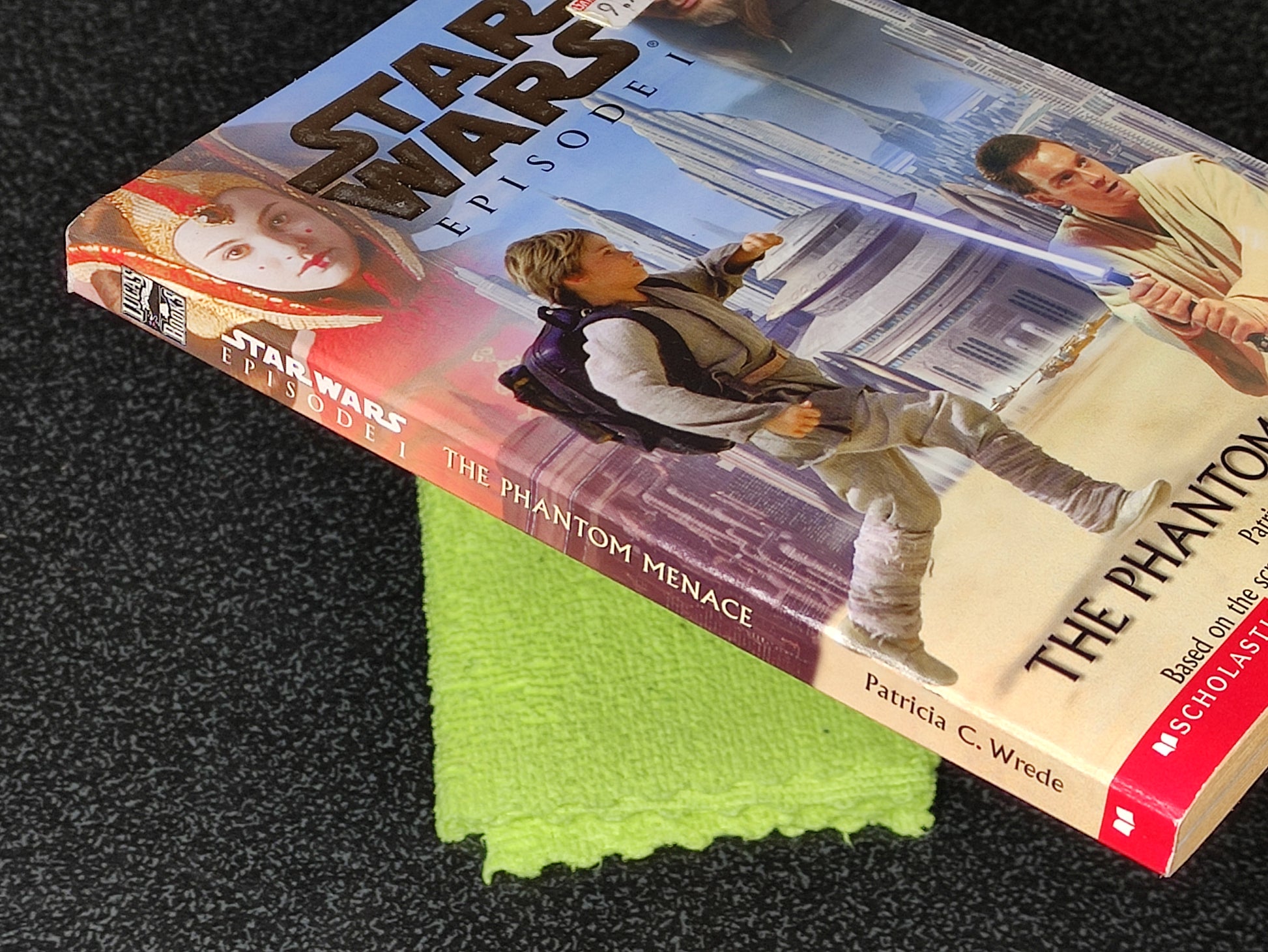 Star Wars book with a green cloth on a dark surface