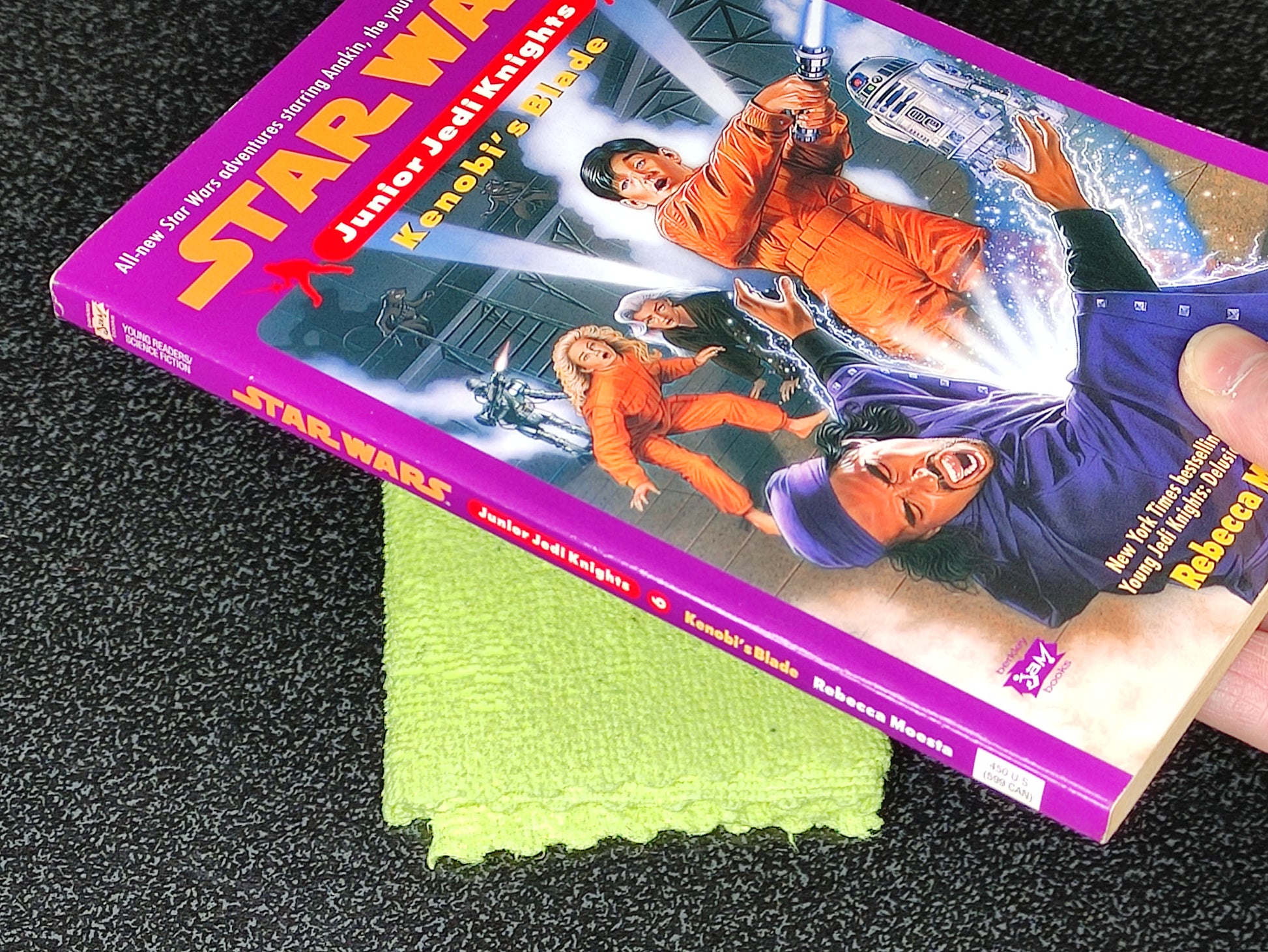 Star Wars book with a green cloth on a dark surface