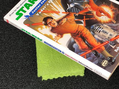 Star Wars Junior Jedi Knight book with a green cloth on a dark surface