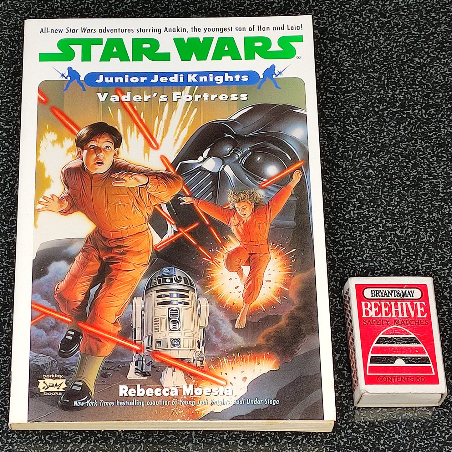 Star Wars book titled 'Vader's Fortress' by Rebecca Miller on a dark textured surface.