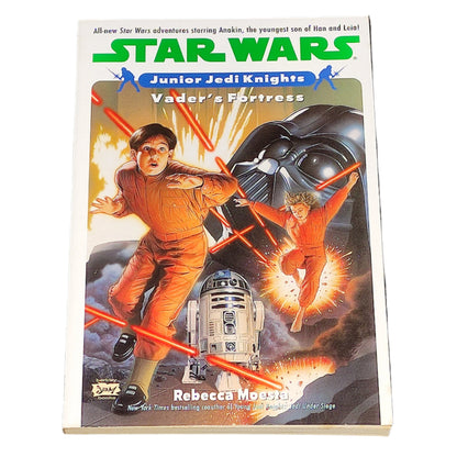 Book cover of 'Star Wars: Junior Jedi Knights - Vader's Fortress' on a textured black surface