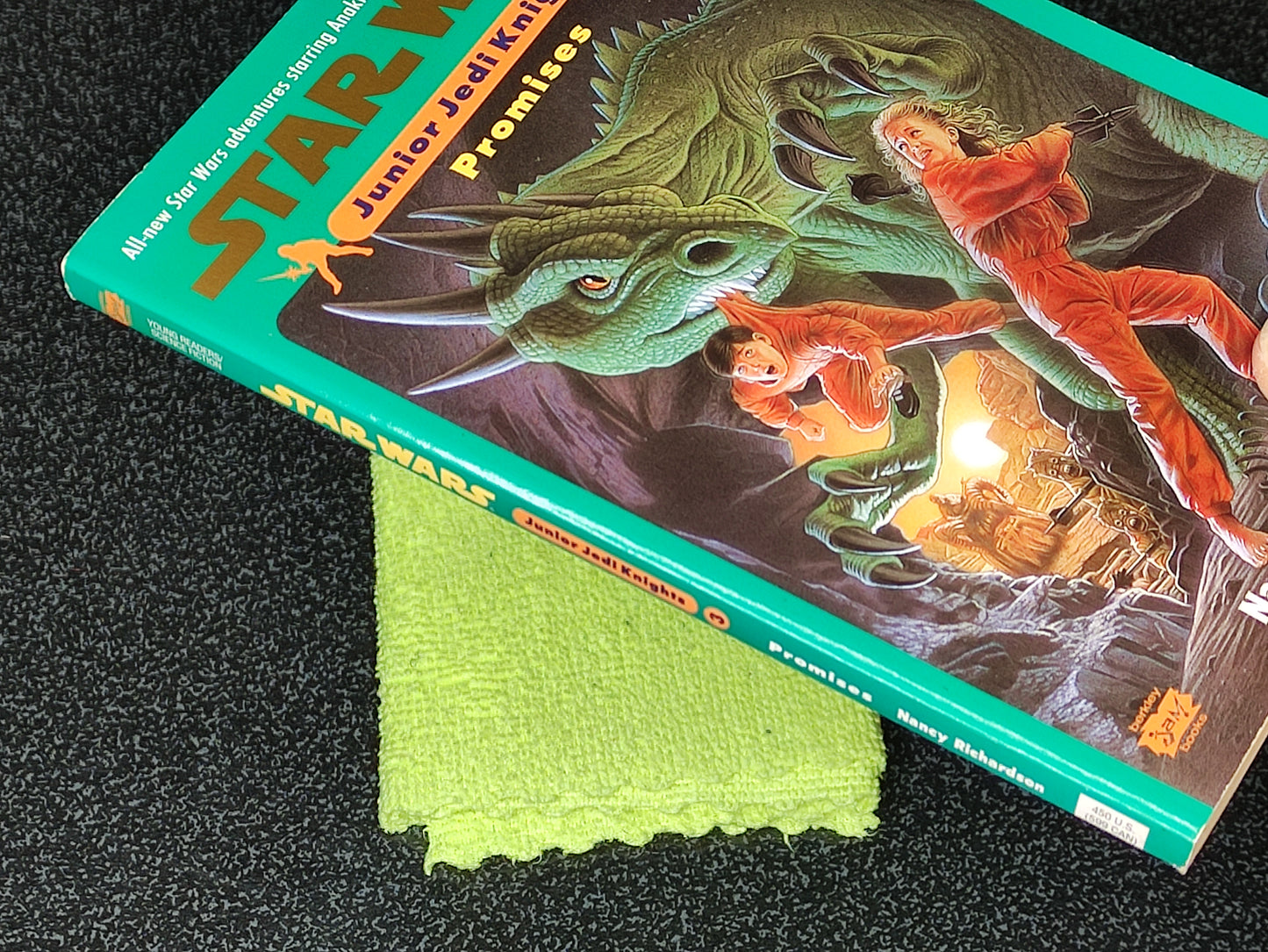 Star Wars Junior Jedi Knight book with a green cloth on a dark surface
