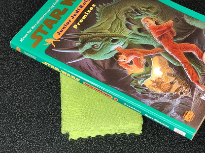 Star Wars Junior Jedi Knight book with a green cloth on a dark surface
