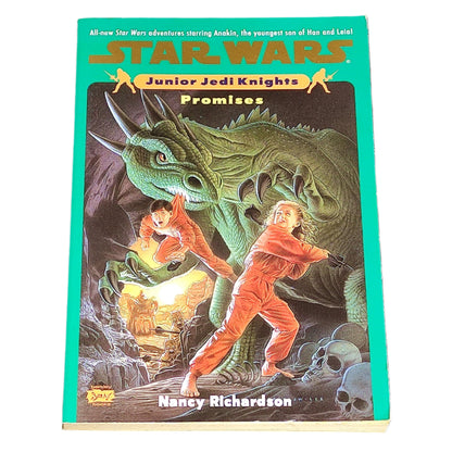 Book titled 'Promises' from the Junior Jedi Knights series in Star Wars on a textured black surface.