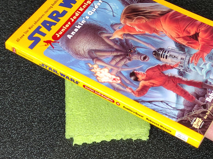 Star Wars Junior Jedi Knight book with a green cloth on a dark surface