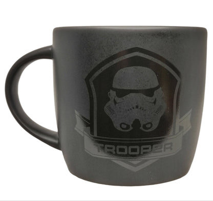 Black mug with 'Trooper' design on a white background