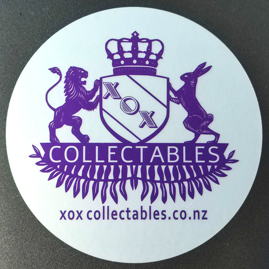 XOX Collectables Coat of Arms Sticker. Purple on reflective matte silver stuck on a Laptop